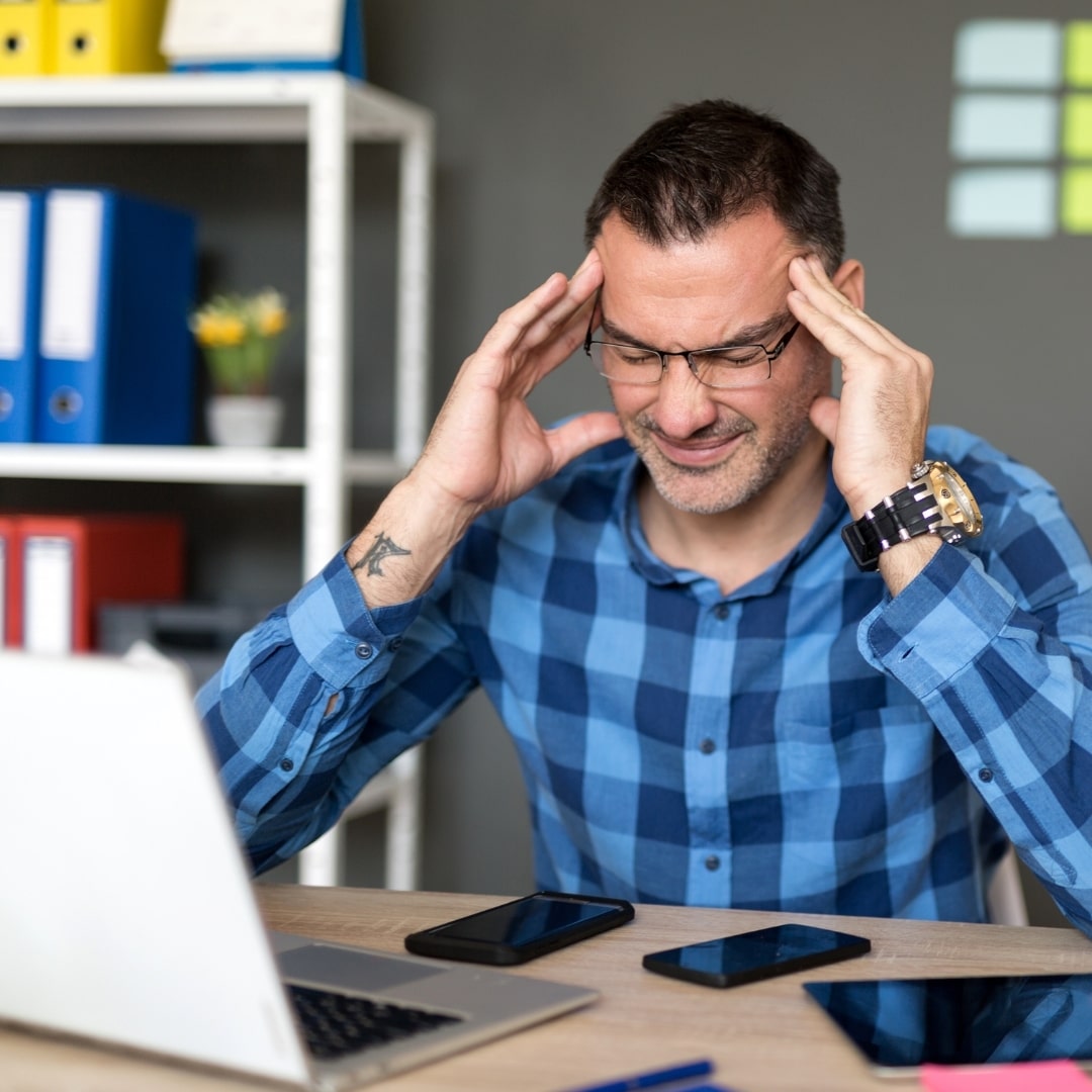 Frustrated person at desk symbolizing SEO challenges for nonprofit websites