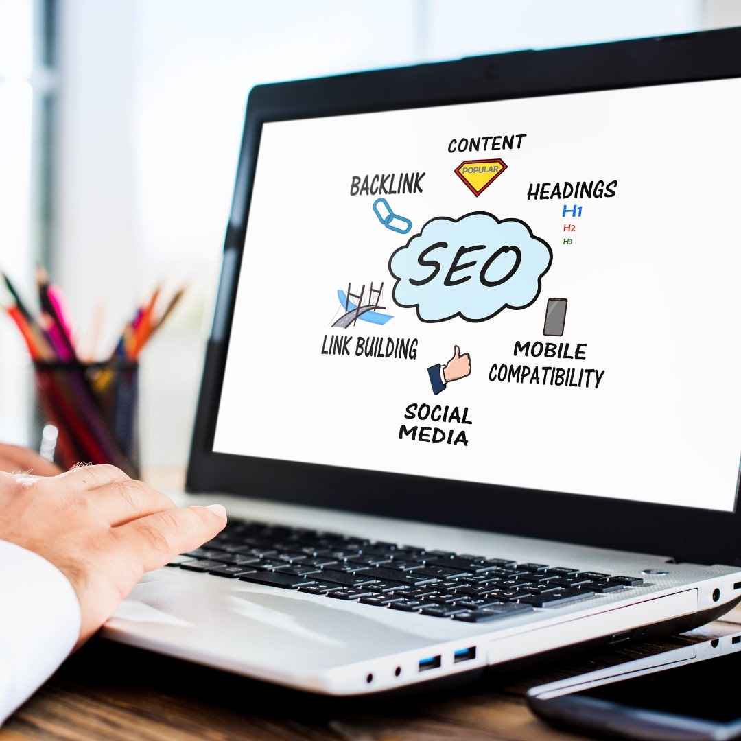 Close-up of a laptop screen displaying an SEO strategy with icons for backlinking, content, and mobile compatibility.