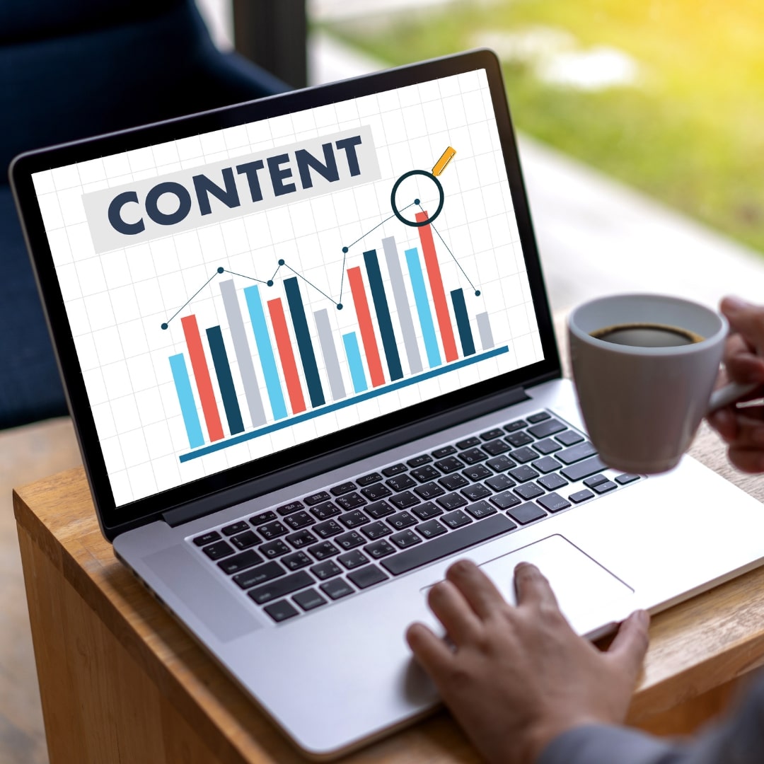 Laptop screen with content analytics graph representing blog content to grow charity website traffic.