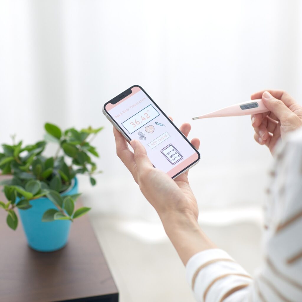 Person holding a smartphone with health tracking app, symbolizing mobile-first design in Mobile SEO for Nonprofits.